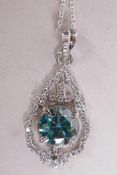A 3ct blue moissanite gemstone pendant surrounded by white cubic zirconia, mounted in sterling