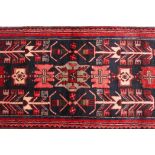 A washed red ground Iranian runner with bespoke black medallion design, 28" x 141"