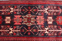 A washed red ground Iranian runner with bespoke black medallion design, 28" x 141"