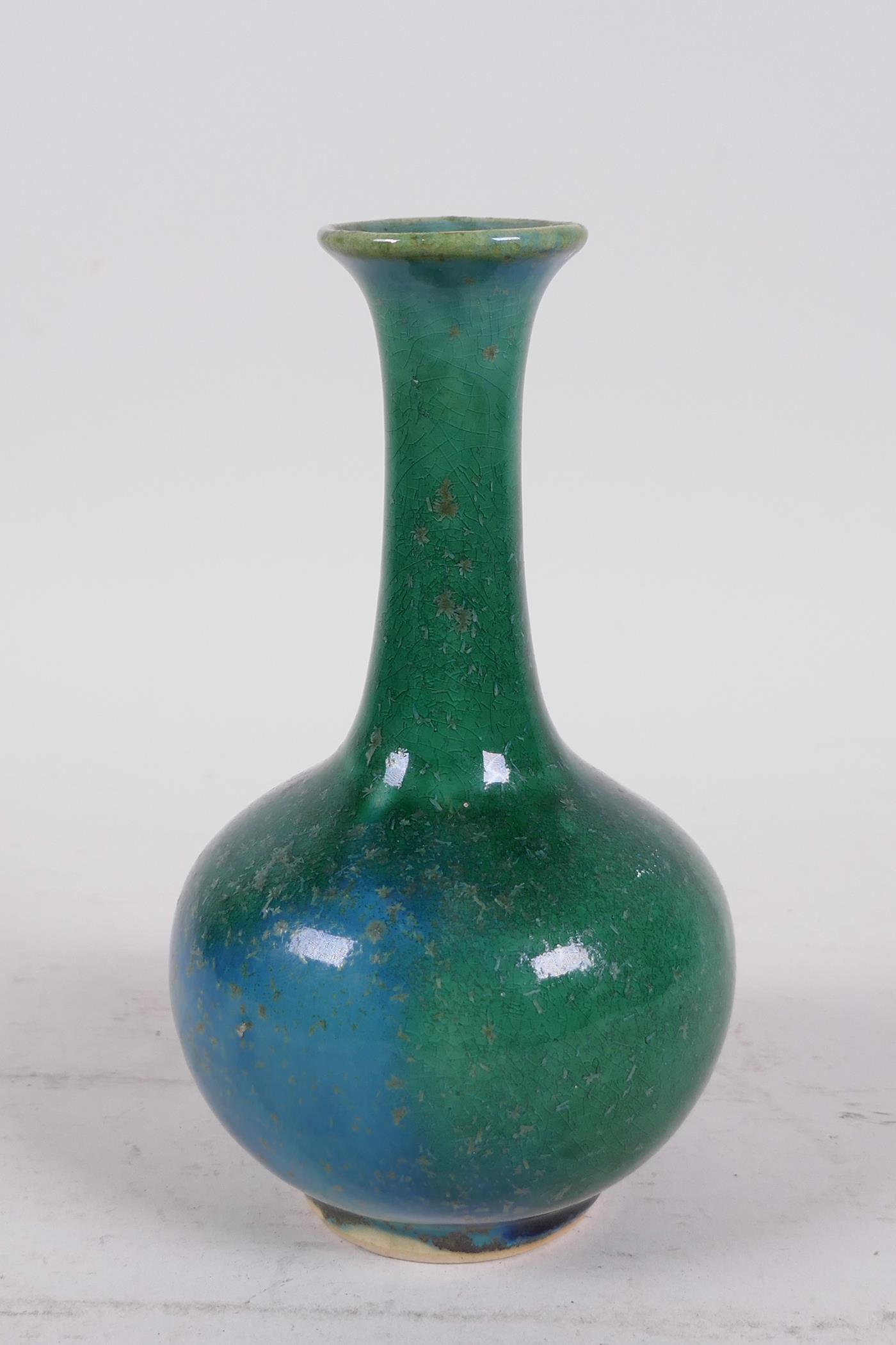 A Chinese mottled green glazed pottery bottle vase, 6" high