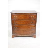 A mahogany bowfront chest of four long drawers, raised on splay supports, with three long drawers