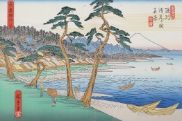 A Japanese block print depicting fishing boats, a seaside village and a distant mount Fuji, 11" x