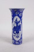 A Chinese blue and white porcelain cylinder vase with a flared rim, with decorative panels depicting