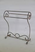 An antique painted wrought metal towel rack, 30" x 35" high