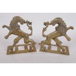 A pair of heraldic brass folding bookends made in the form of a lion rampant reguardant, 5½" high