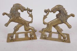 A pair of heraldic brass folding bookends made in the form of a lion rampant reguardant, 5½" high