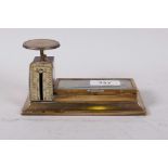 An antique brass spring letter balance, measuring to 12 oz, complete with stamp tray under