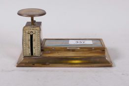 An antique brass spring letter balance, measuring to 12 oz, complete with stamp tray under