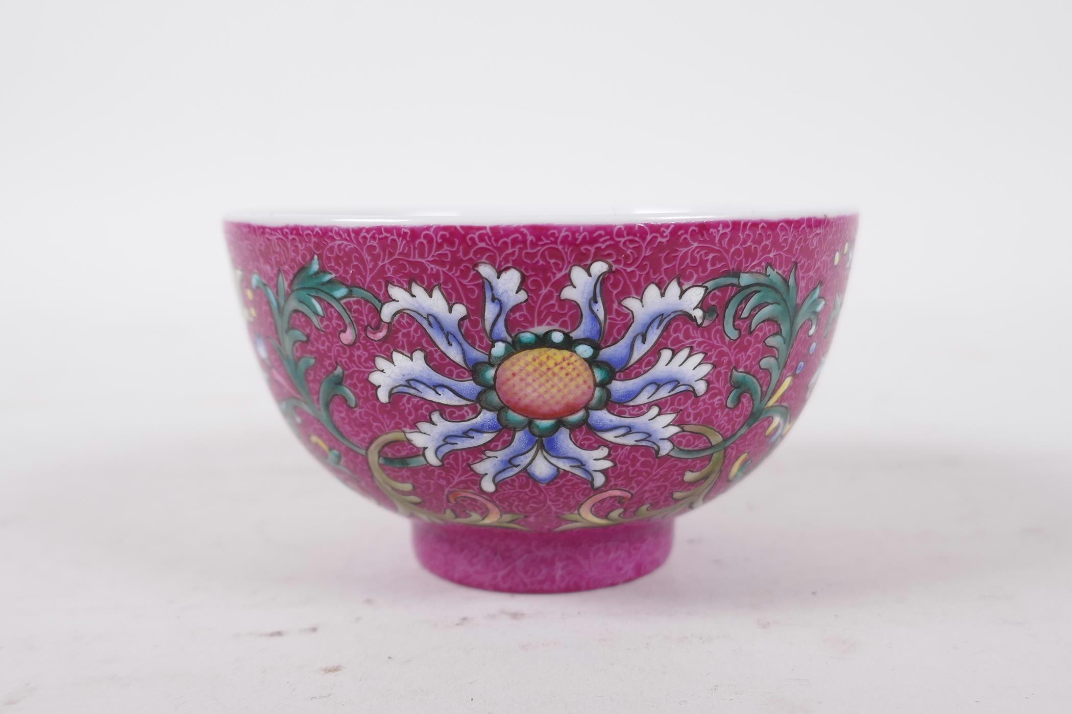 A Chinese polychrome porcelain tea bowl, with enamel lotus flower decoration on a pink ground, - Image 3 of 6