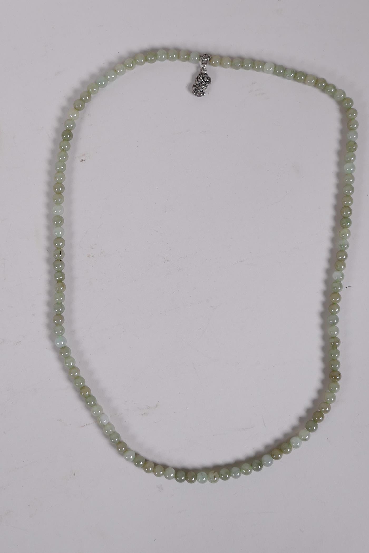 A Chinese celadon jade necklace, 27" long