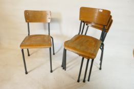 A set of four Czech mid century bent ply and tubular steel framed industrial stacking chairs,