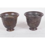 A pair of Chinese bronze wine cups with embossed decoration, 1½" high