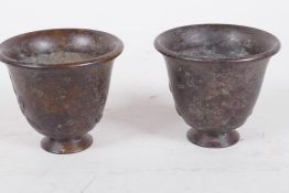 A pair of Chinese bronze wine cups with embossed decoration, 1½" high