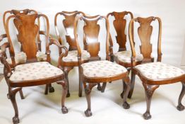 A set of six (four and two) Georgian style walnut dining chairs with carved scroll decoration and