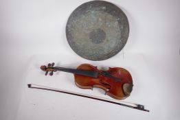 A vintage violin with a two piece back, A/F, and a bow, together with a bronze gong, violin 24" long