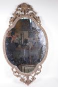 A gilt composition wall mirror with clam shell and swag decoration, 19½" x 35"