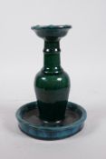 A Chinese green/blue glazed pottery candlestick, indistinctly signed to base, 7½" high"