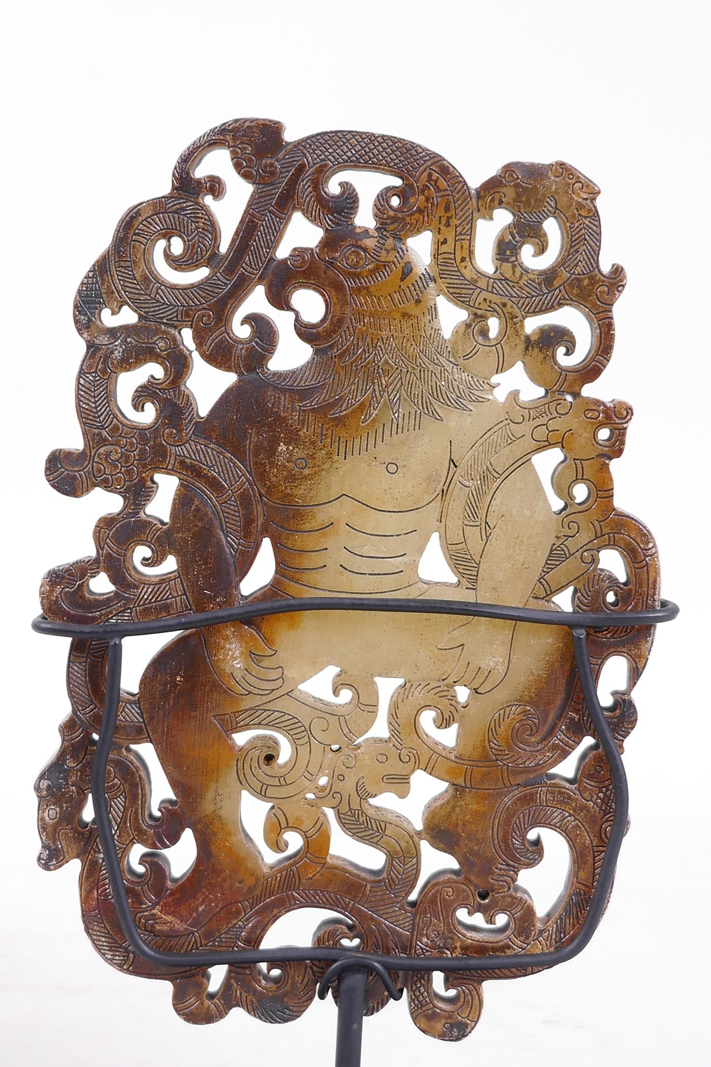 A Chinese pierced jade ornament, carved in the form of a bird headed man entwined with dragons, on a - Image 3 of 3