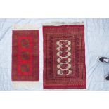 A red ground Turkmen wool rug with a Bokhara design on a cream field, 32" x 48", and another