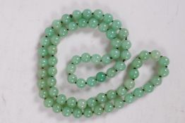 A string of pale green jade beads, 34" long