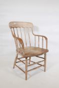 A C19th beechwood desk chair with bentwood arms and spindle back