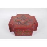 A Chinese red lacquer box with engraved and painted dragon decoration to cover and sides, 9½" x 9½"