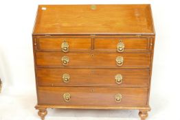 A C19th walnut fall front bureau with fitted interior and two over three drawers with pressed