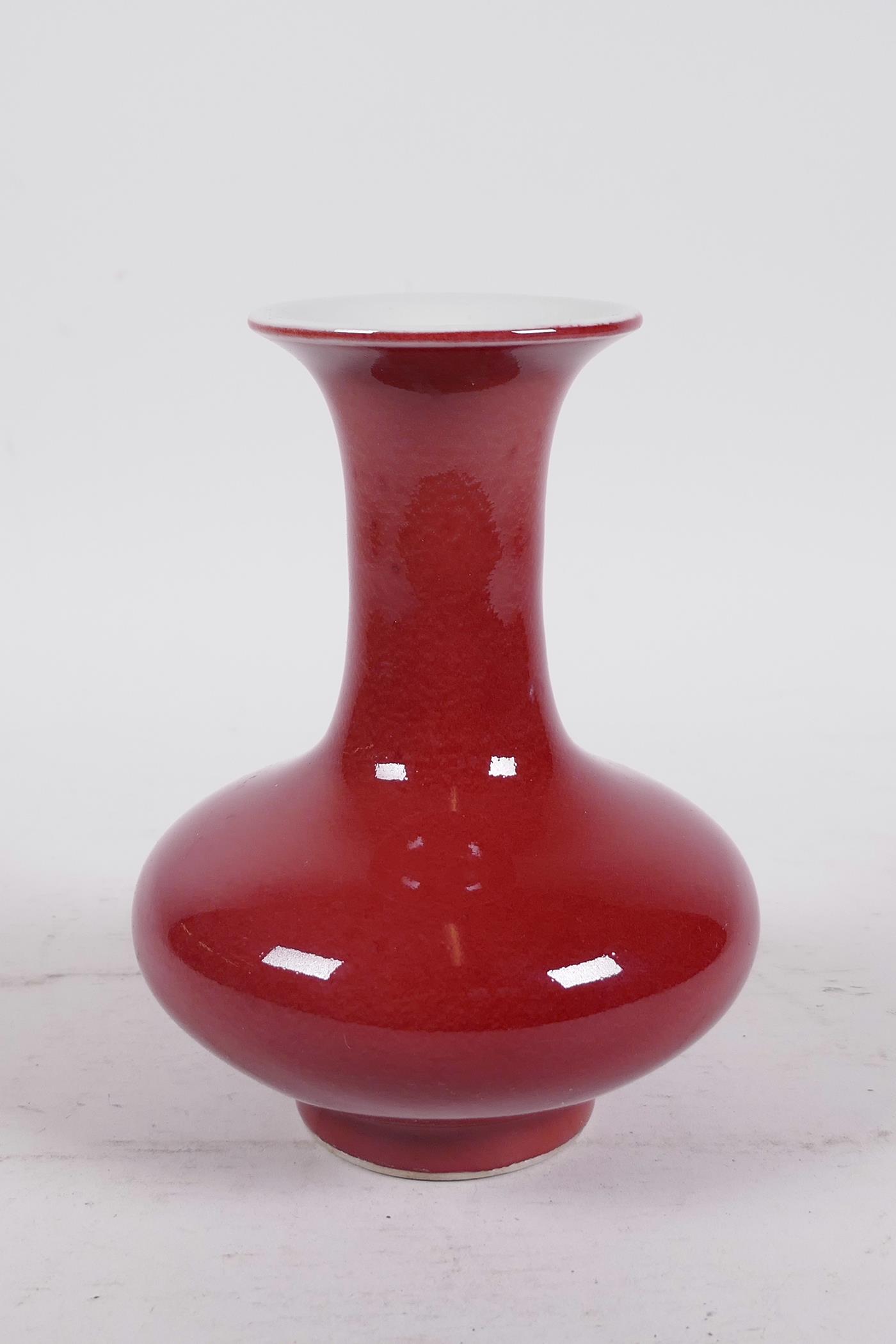 A Chinese sang de boeuf glazed porcelain vase of squat form with a flared rim, 5½" high