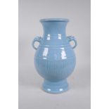 A Chinese blue glazed porcelain two handled vase with incised underglaze decoration, seal mark to