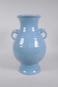 A Chinese blue glazed porcelain two handled vase with incised underglaze decoration, seal mark to