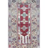 A Persian full pile multicolour ground wool carpet, the central panel with floral medallions on a