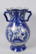 A Chinese two handled blue and white porcelain vase decorated with a variation of the Willow