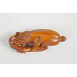 A Chinese carved deer horn snuff bottle in the form of a gourd, 3½" long