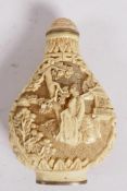 A decorative Chinese composition snuff bottle carved to both sides with figures in garden scenes,