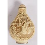 A decorative Chinese composition snuff bottle carved to both sides with figures in garden scenes,