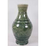 A heavy Oriental dark green celadon glazed vase with ribbed and pin head decoration, 13" high,