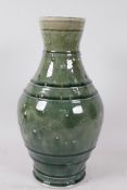 A heavy Oriental dark green celadon glazed vase with ribbed and pin head decoration, 13" high,