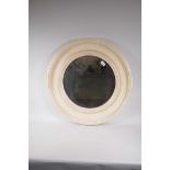 A circular bevelled glass wall mirror in a dished moulded frame, 26½" diameter