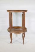 A mahogany and beechwood cylinder shaped vitrine, with brass mounts, and inset bevelled glass top,