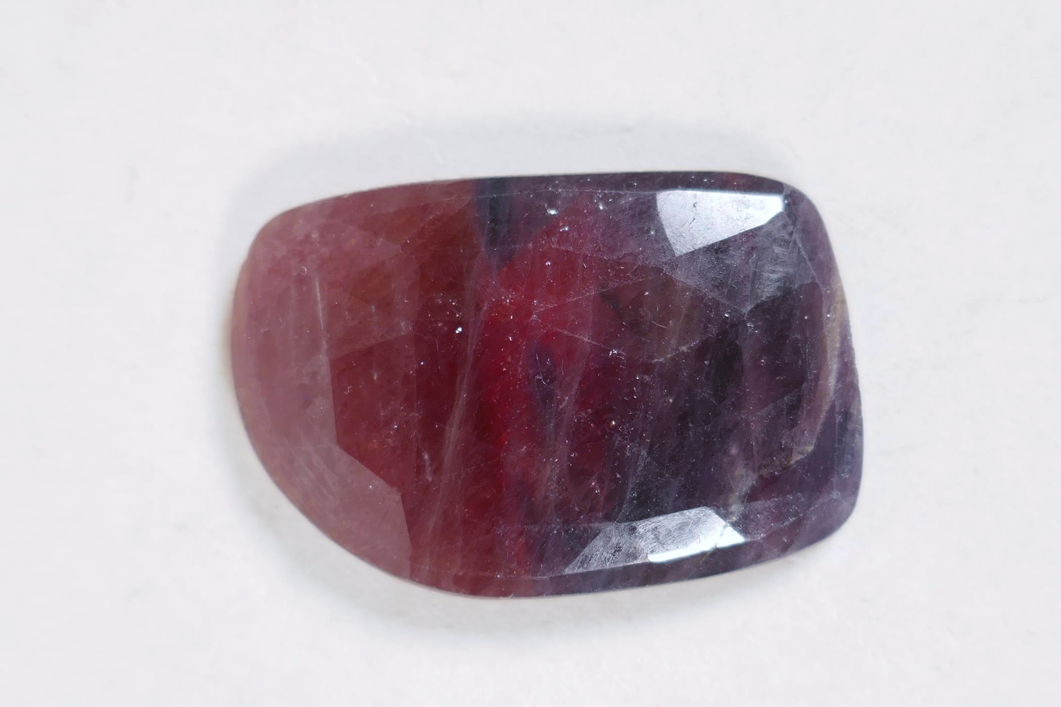 A 55.06ct natural multicoloured sapphire, uneven cut, IDT certified, with certificate