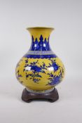 A Chinese yellow ground porcelain vase with blue and white decoration of branches bearing fruit