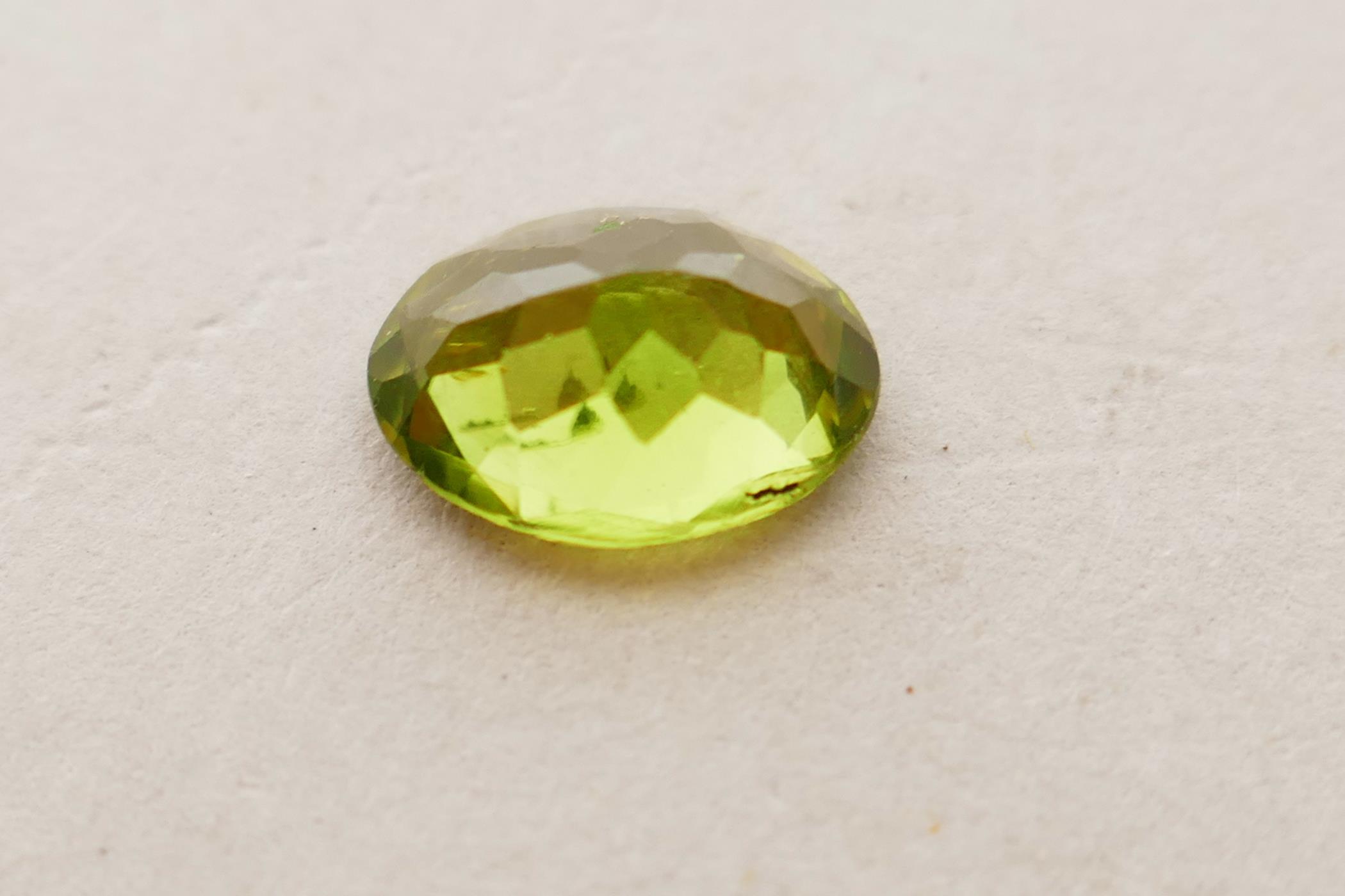 A 1.99ct peridot, oval mixed cut, ITLGR certified, with certificate - Image 4 of 8