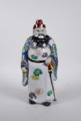 A Chinese polychrome porcelain figure of an Immortal, 11" high
