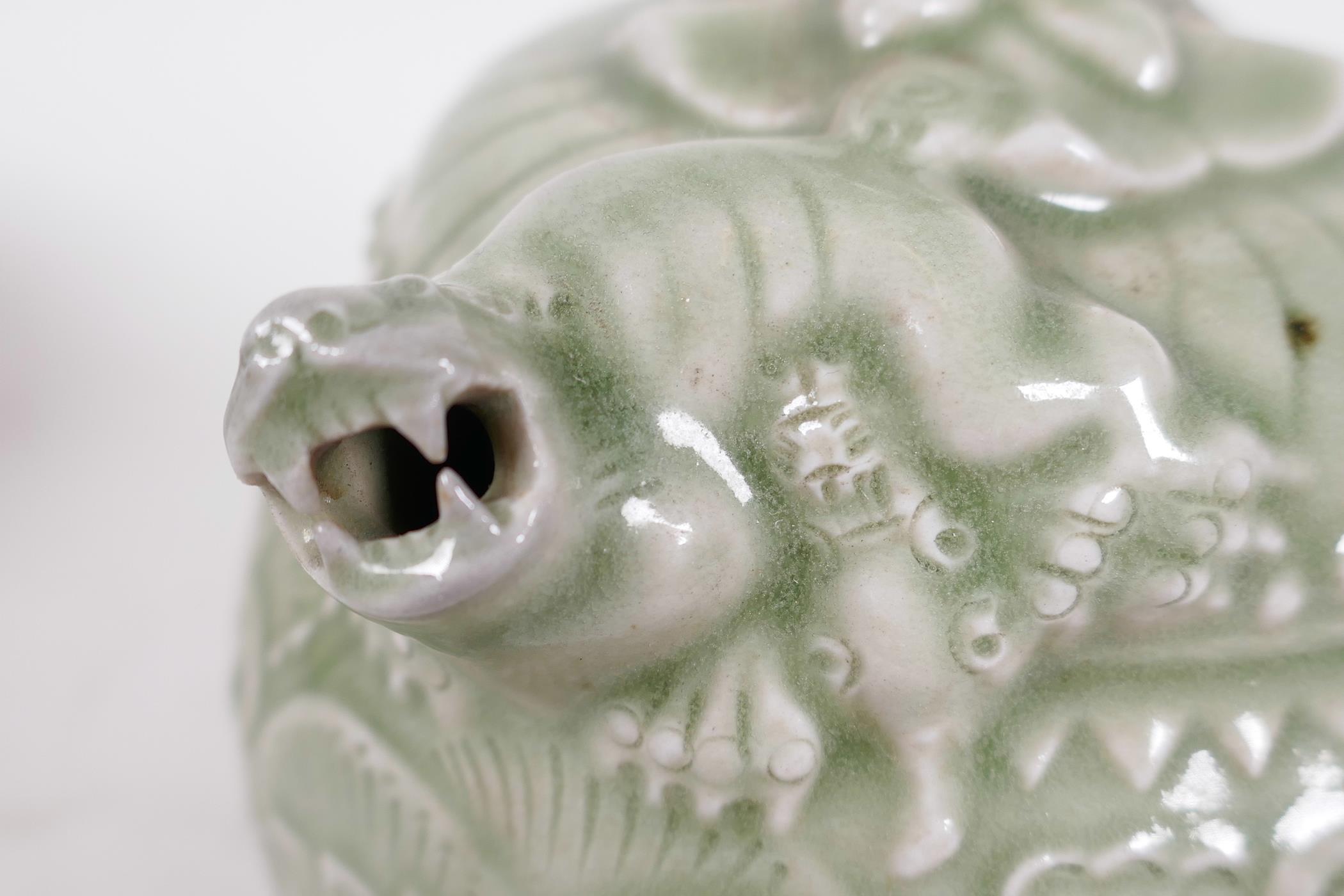 A Chinese celadon water dropper with embossed body, the spout formed as a mythical beast, 6¼" high - Image 4 of 4