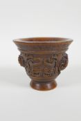 A Chinese faux horn libation cup with carved kylin handles, impressed seal mark to base, 3" high, 4"