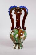 A Chinese Sancai glazed pottery vase with a slender neck and two handles in the form of dragons,