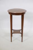 An early C20th mahogany two tier lamp table, with mother of pearl inlaid top, raised on tapering