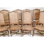 A set of six and two French style beechwood chairs, with caned seats and backs and carved