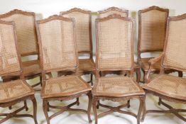 A set of six and two French style beechwood chairs, with caned seats and backs and carved