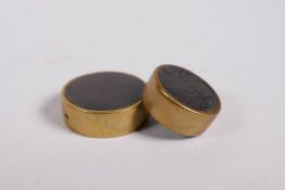 A brass bound horn bead and another smaller, 1¼" diameter